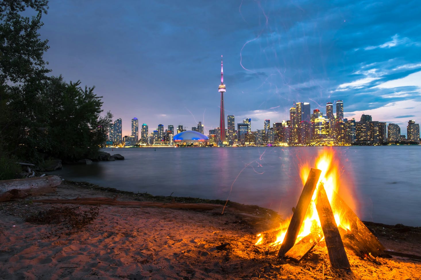 A campfire at dusk at Centre Island Beach near Toronto