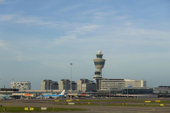 View of Amsterdam Schipol Airport, its control tower and the parked planes