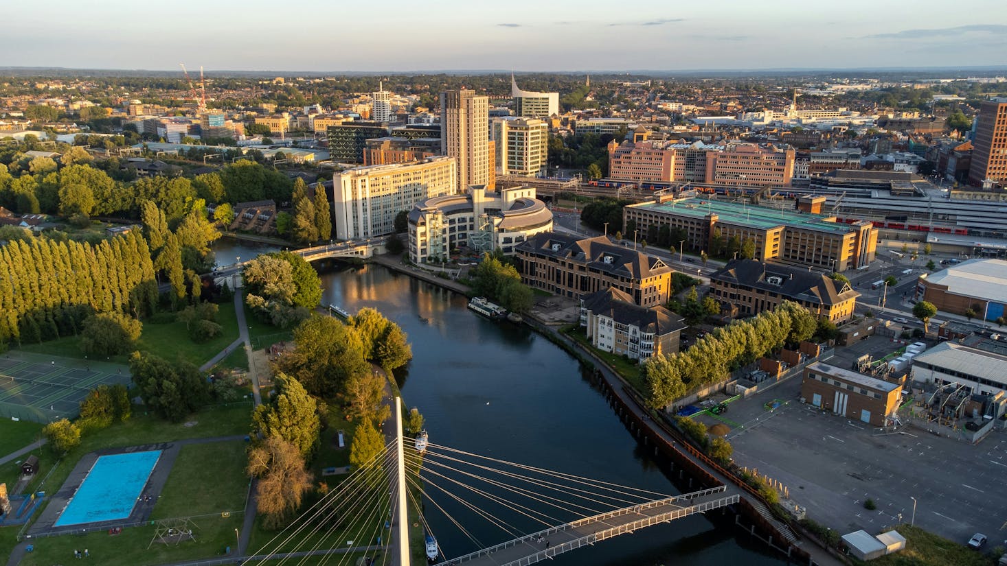 Aerial view of the sunny Reading Town Centre with the Thames River and tall buildings