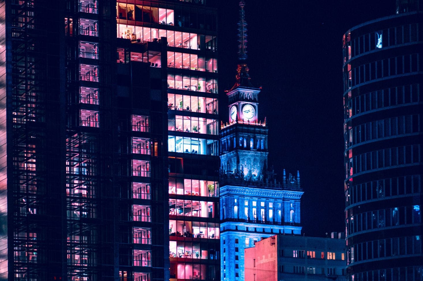 Night view of Warsaw with the lit-up Palace of Culture and Science and surrounding tall buildings