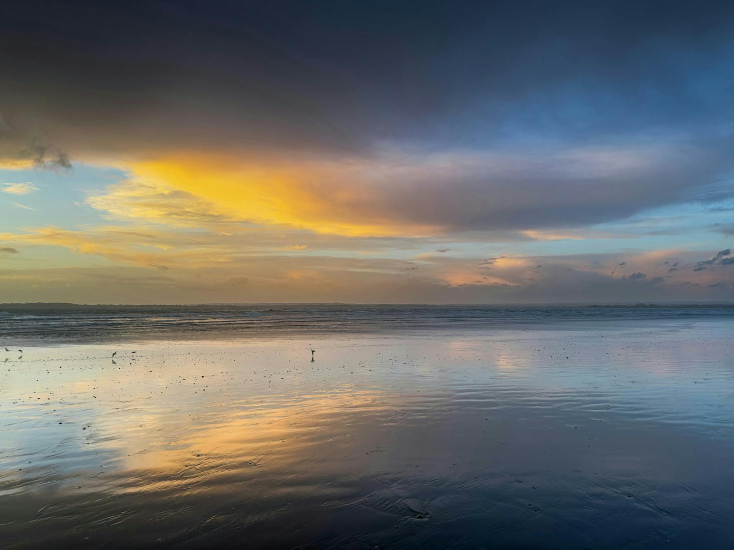 The calm waters at West Wittering Beach near Brighton at sunset