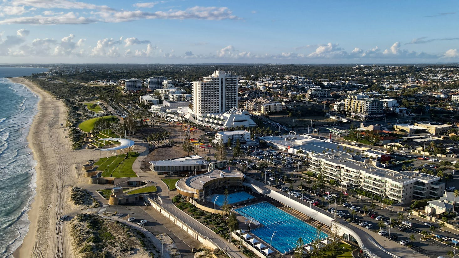 Aerial view of the coastline near Perth with a large swimming pool and grassy areas