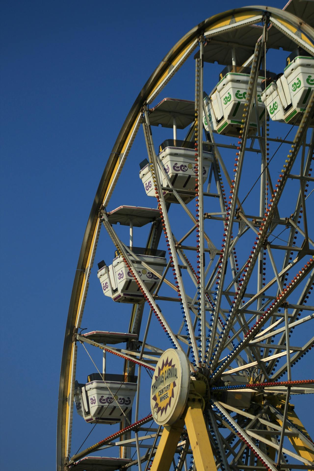 Large Ferris wheel under a clear blue sky at a state fair