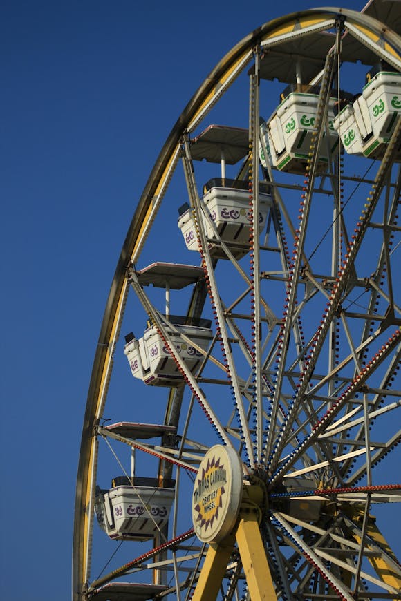 Large Ferris wheel under a clear blue sky at a state fair