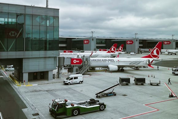 Turkish Airlines planes parked on the runway with pushback tugs at IST Airport, Istanbul