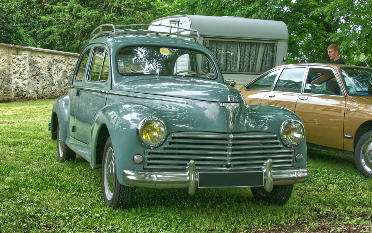 Vintage Peugeot 203 on trimmed grass during the day