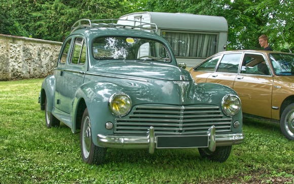 Vintage Peugeot 203 on trimmed grass during the day