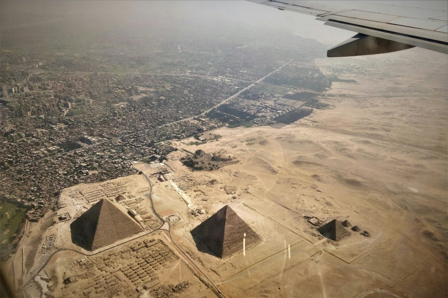 Aerial view of Cairo's sandy landscape and the pyramids from the plane