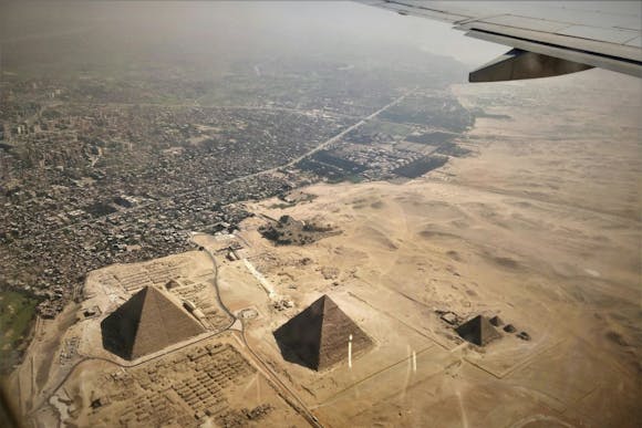 Aerial view of Cairo's sandy landscape and the pyramids from the plane