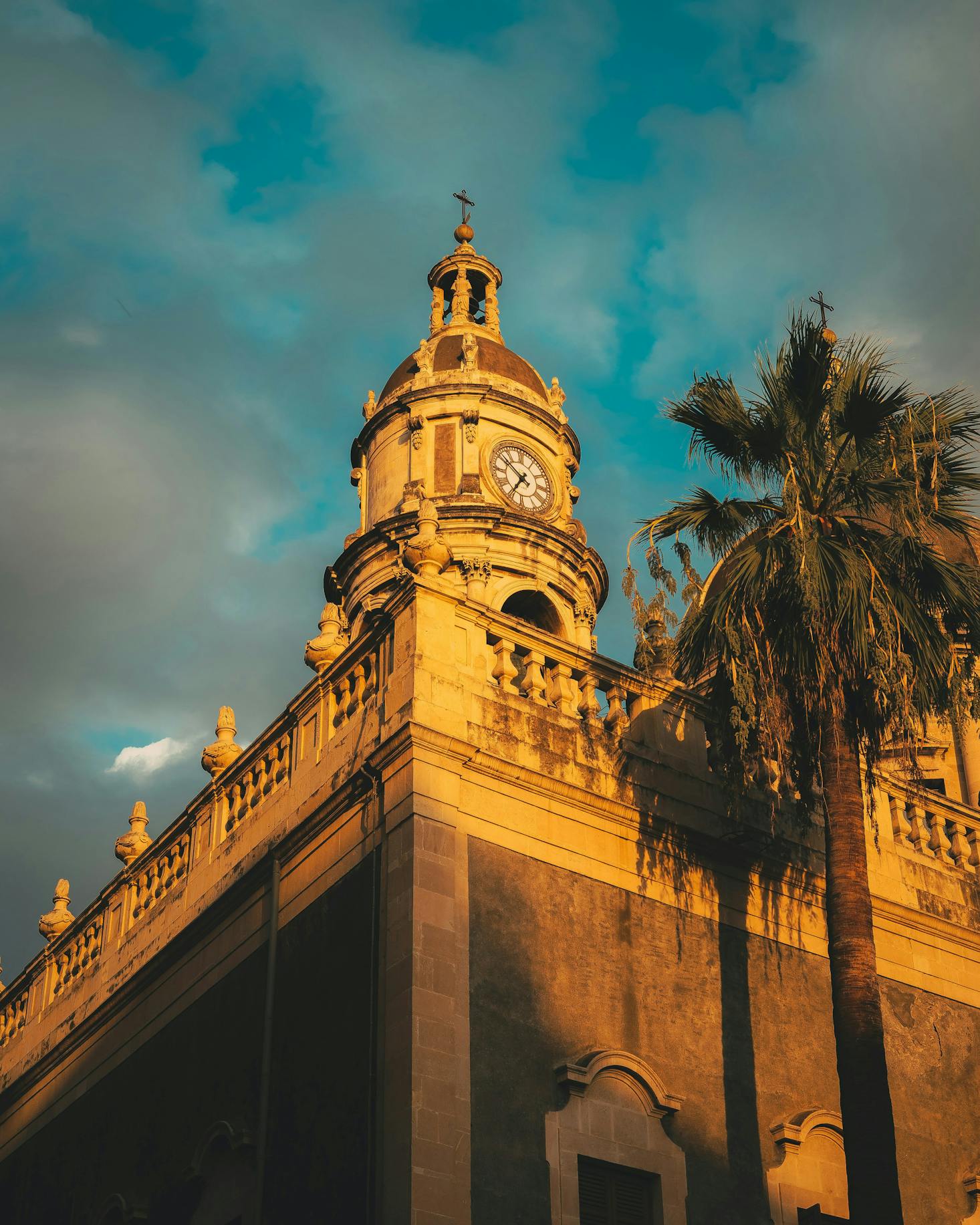 A clock tower in Catania at golden hour, just before sunset