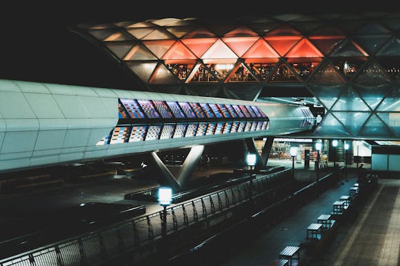 Reykjavik Airport lit up at night with a colorful mosaic of Crossrail design