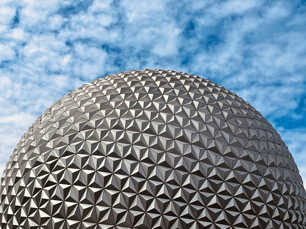 EPCOT's magnificent ball under a blue and cloudy sky in Orlando