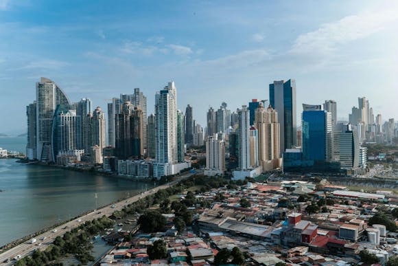 Panama City's skyline with modern skyscrapers and older, modest neighborhood houses overlooking the waterfront