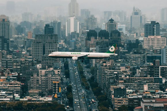 A plane flying over Taipei, Taiwan, with the cityscape beneath