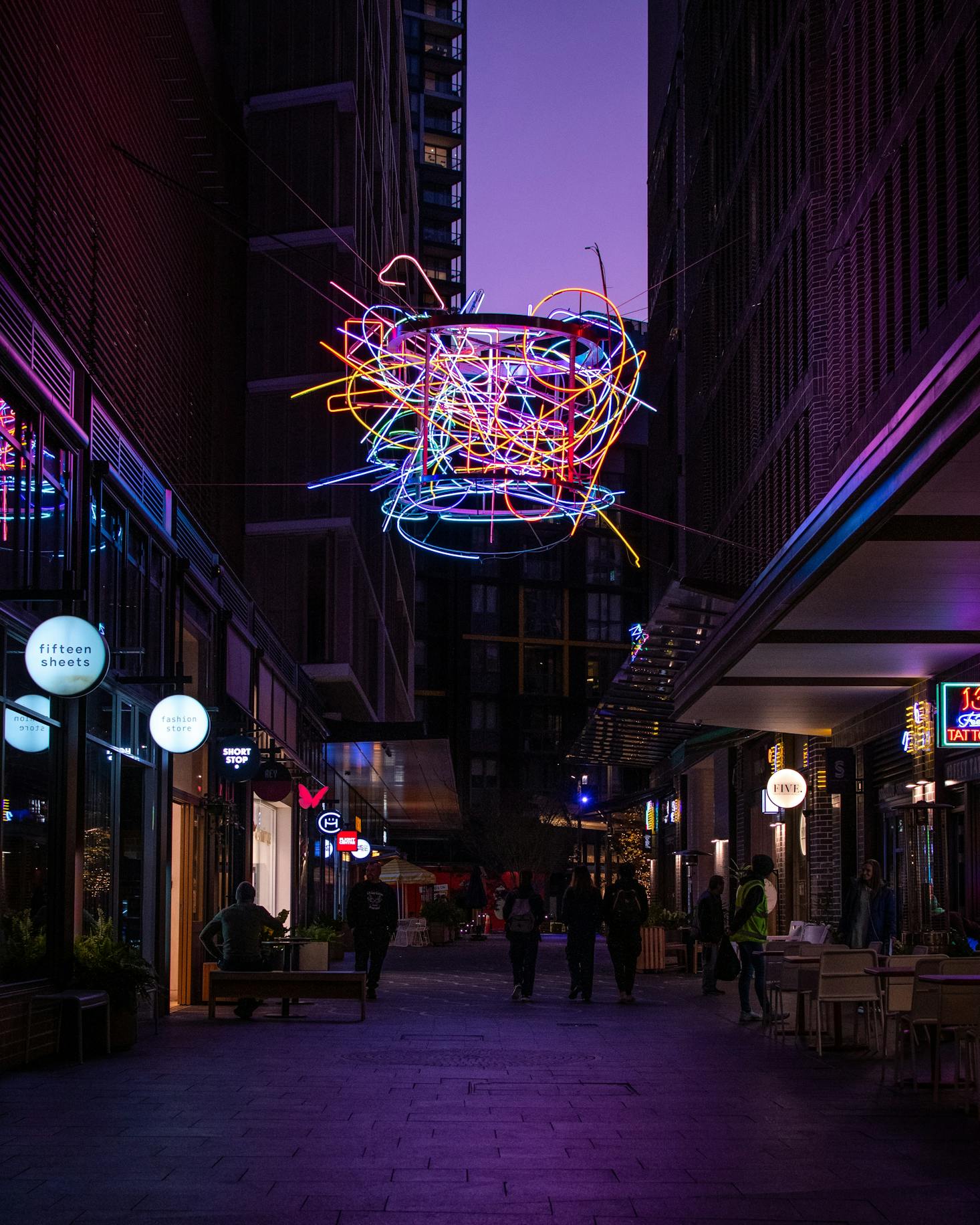 The promenade at Darling Harbour in Sydney at night with neon lights