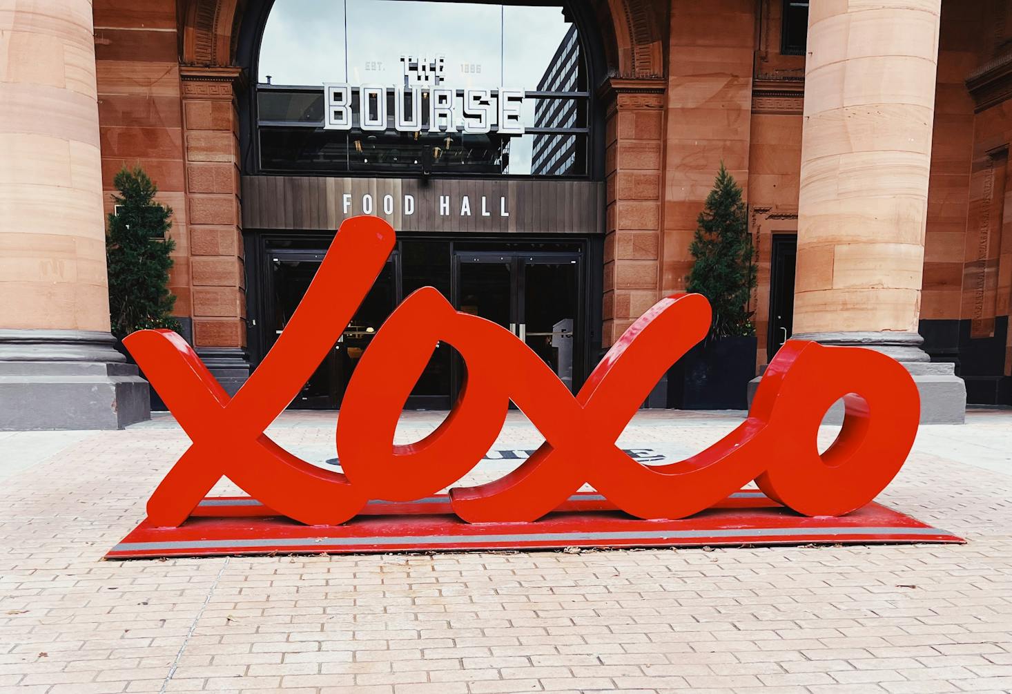 An "XOXO" red sign in Philadelphia in front of a shop