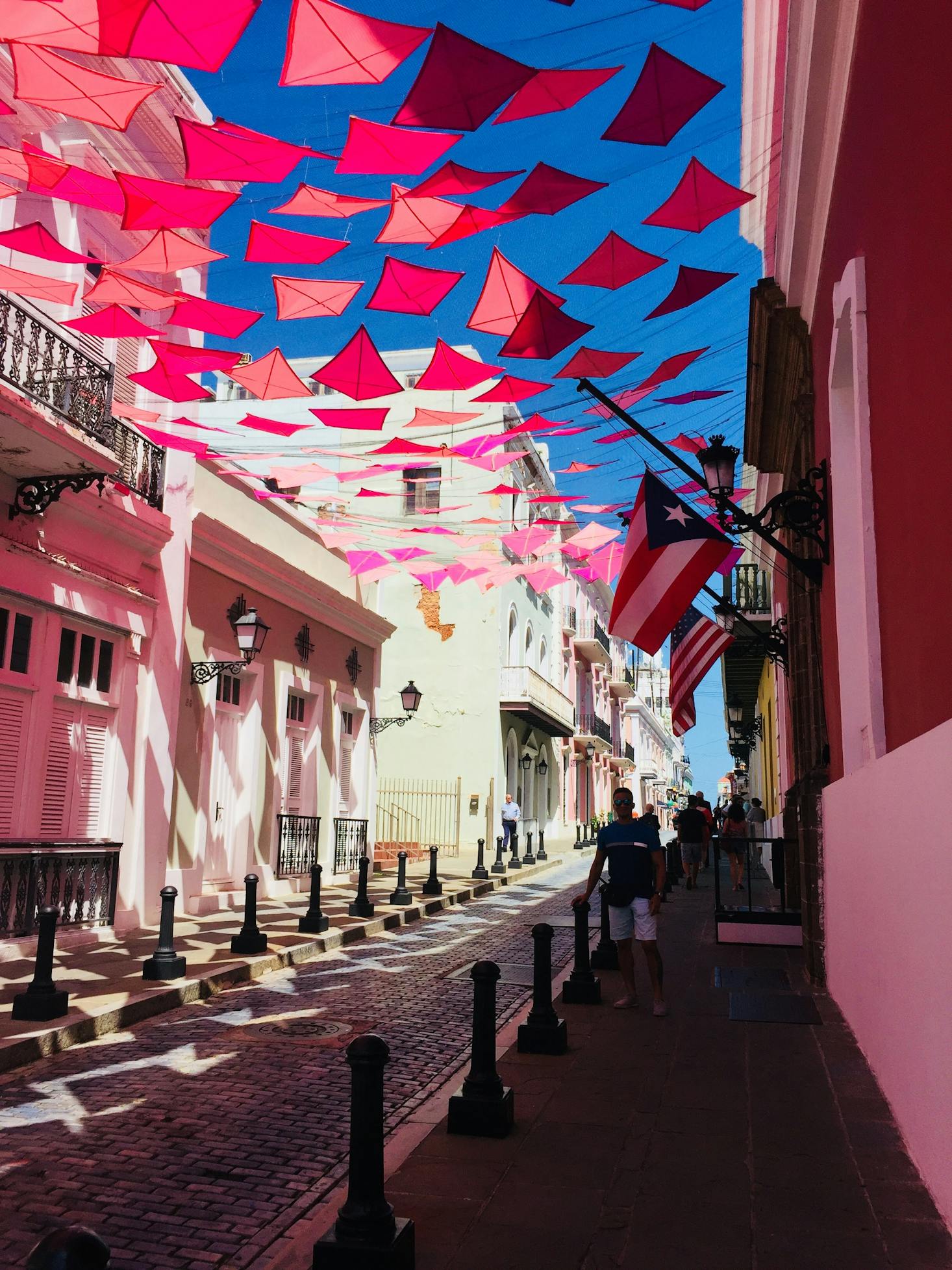 Brightly-colored street with pink flags in Old San Juan, Puerto Rico