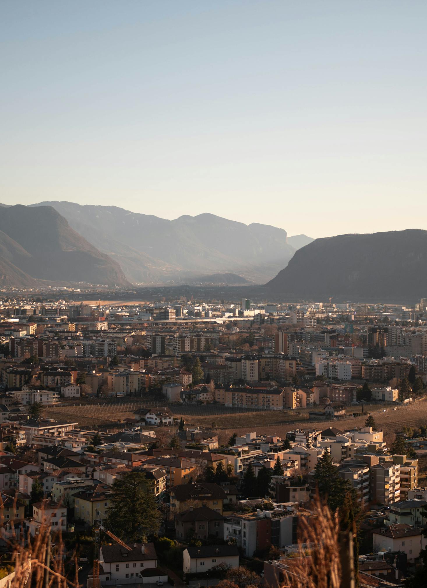 Aerial view over Bolzano with surrounding Dolomite mountains