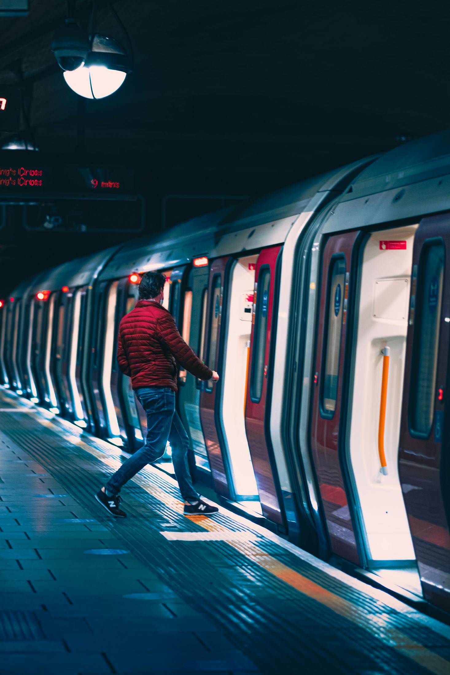 Person getting on a subway train at South Kensington Station