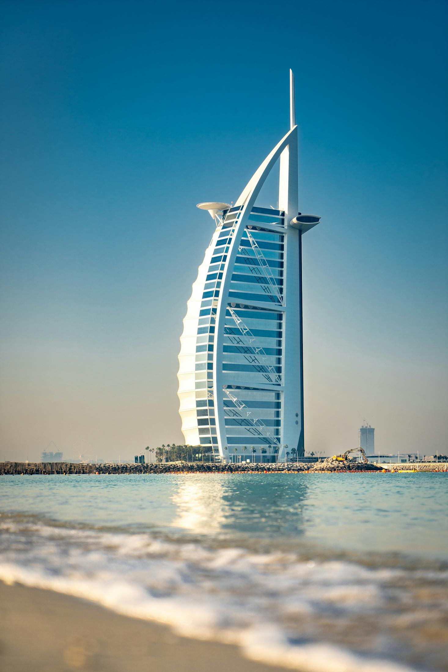 The Burj Al Arab looks over the turquoise ocean in Dubai