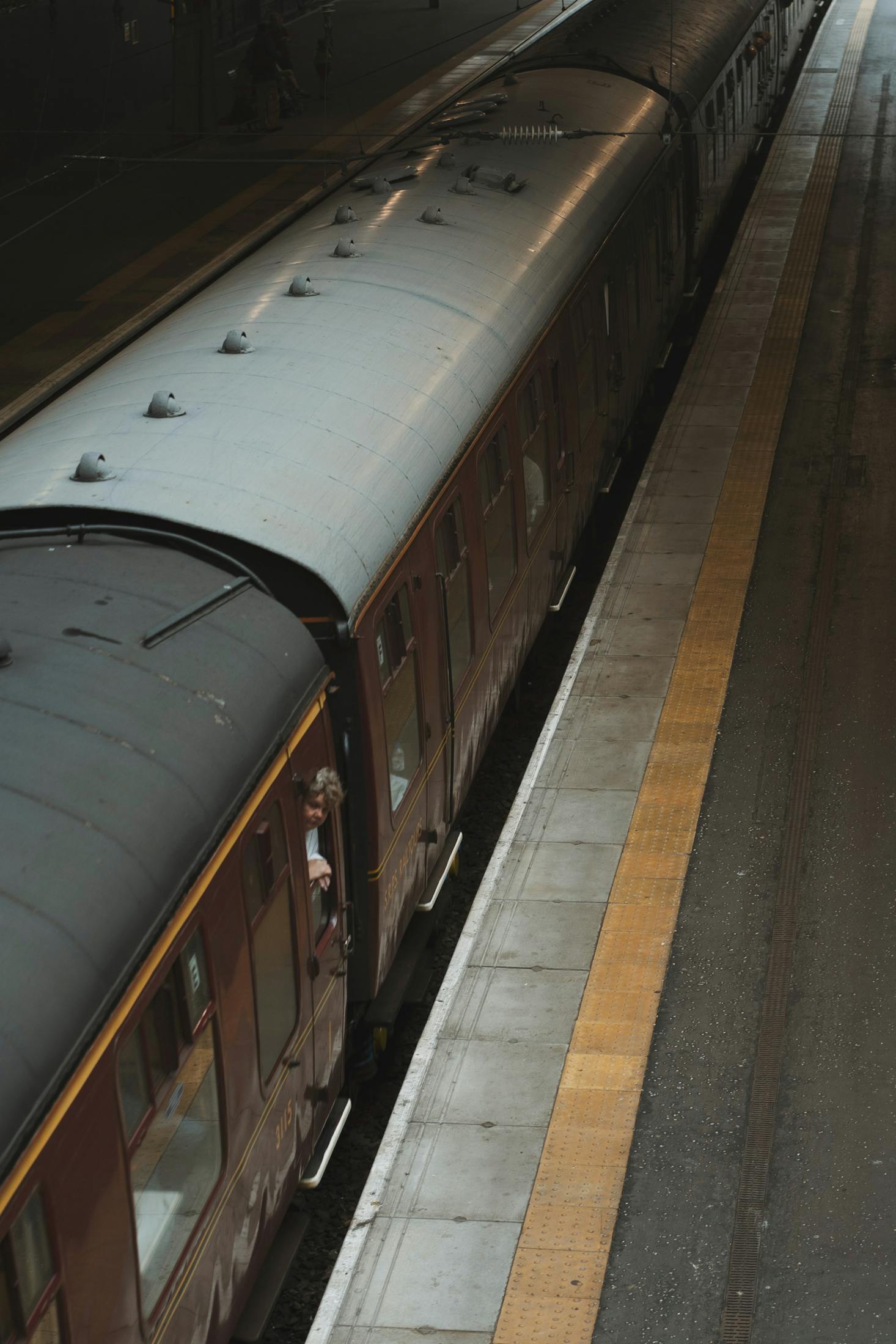 A train on the tracks at a platform at Waverley Station in Edinburgh