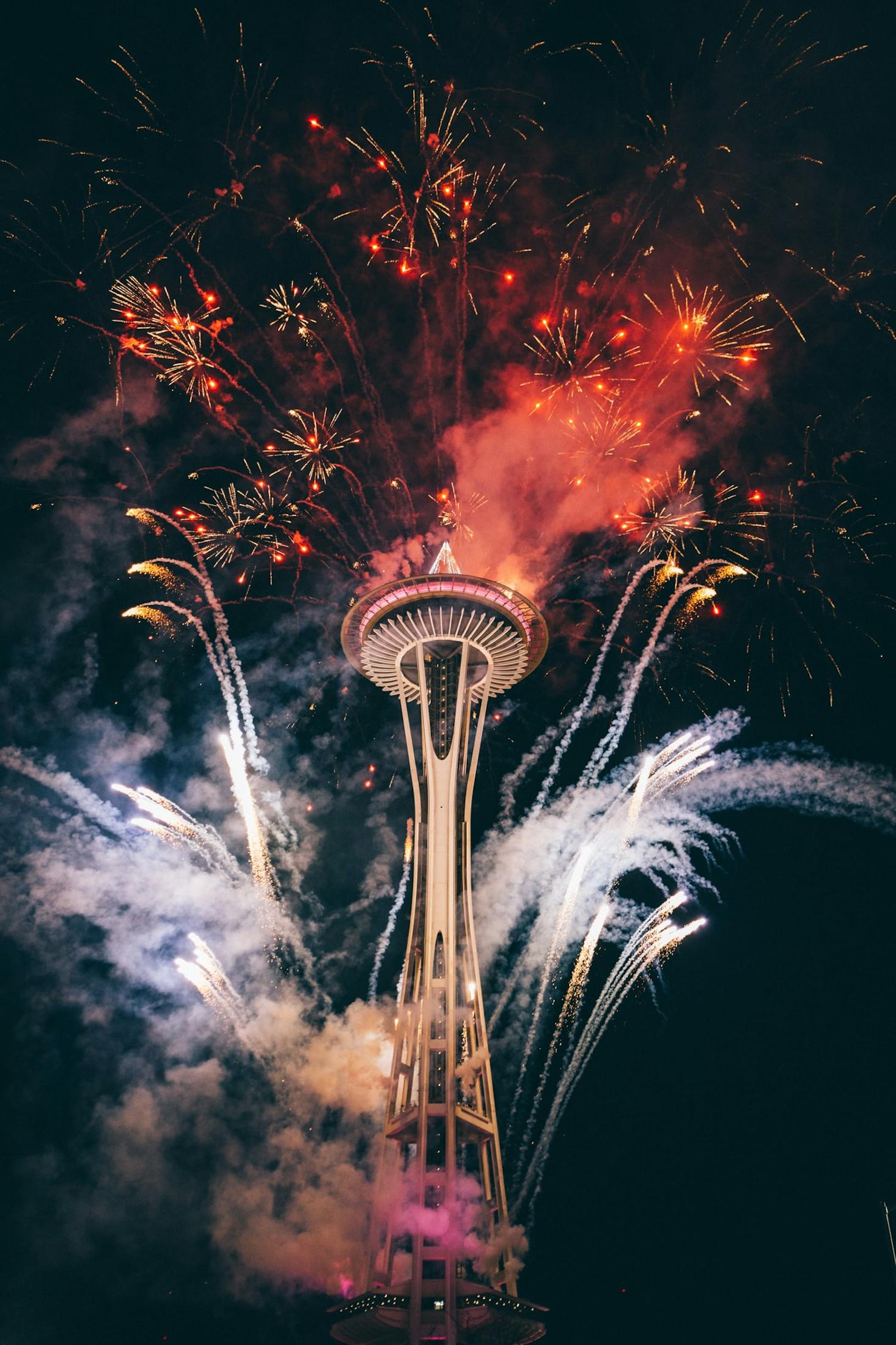 The Space Needle at night with fireworks near Pier 66 in Seattle