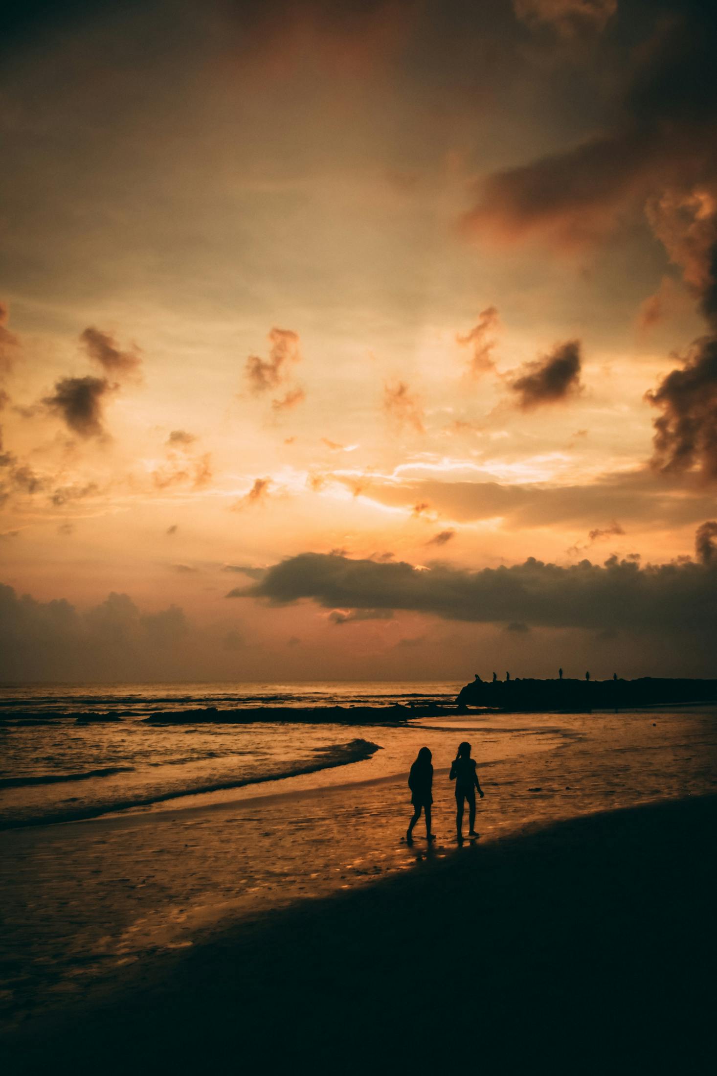 The sunset over the water at the beach in Canggu, Bali