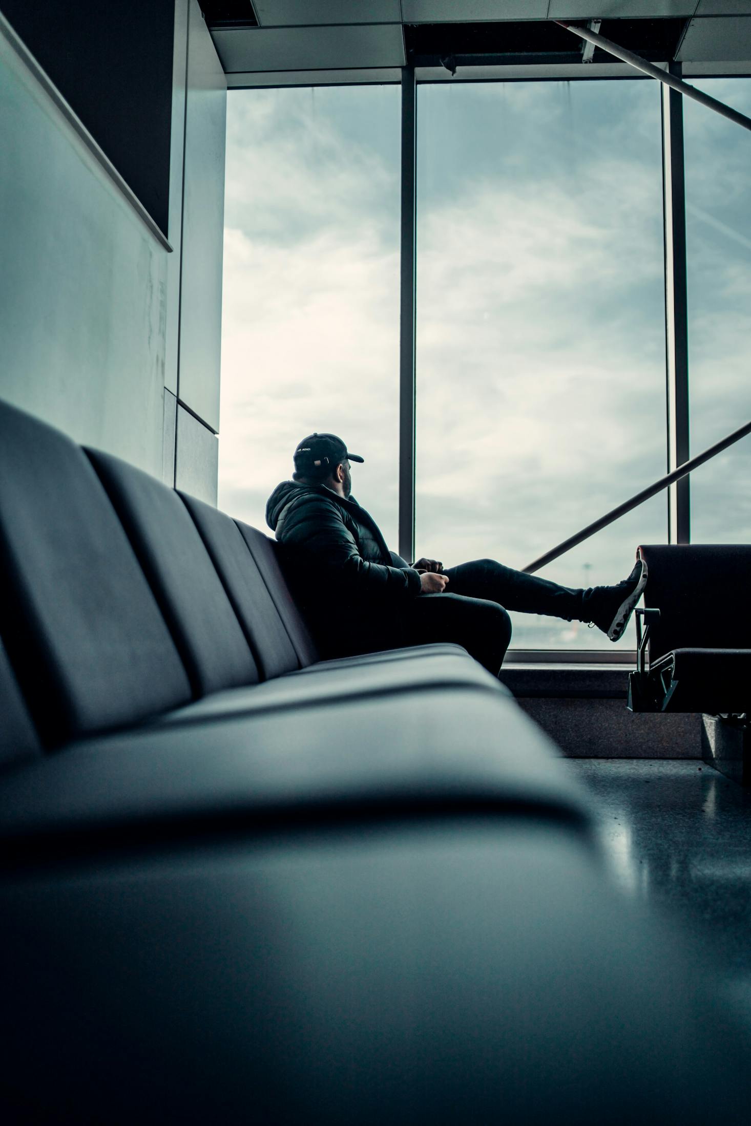 Person sitting in a lounge at Manchester Airport in the UK