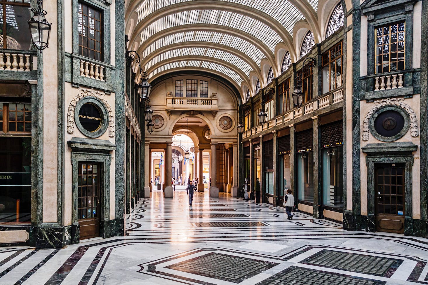 A historic and ornate indoor shopping mall in Turin