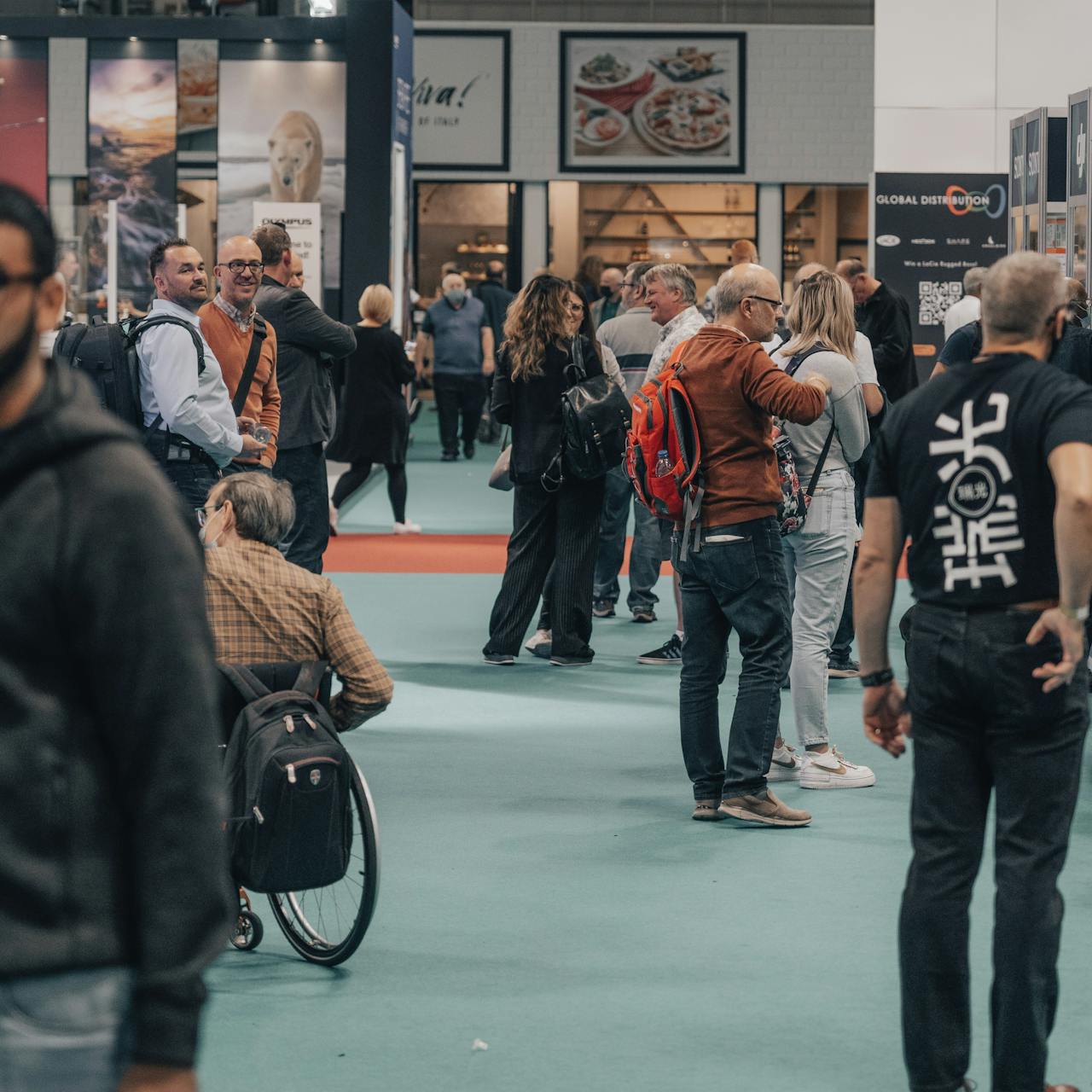 Attendees interacting and observing displays at an exhibition 