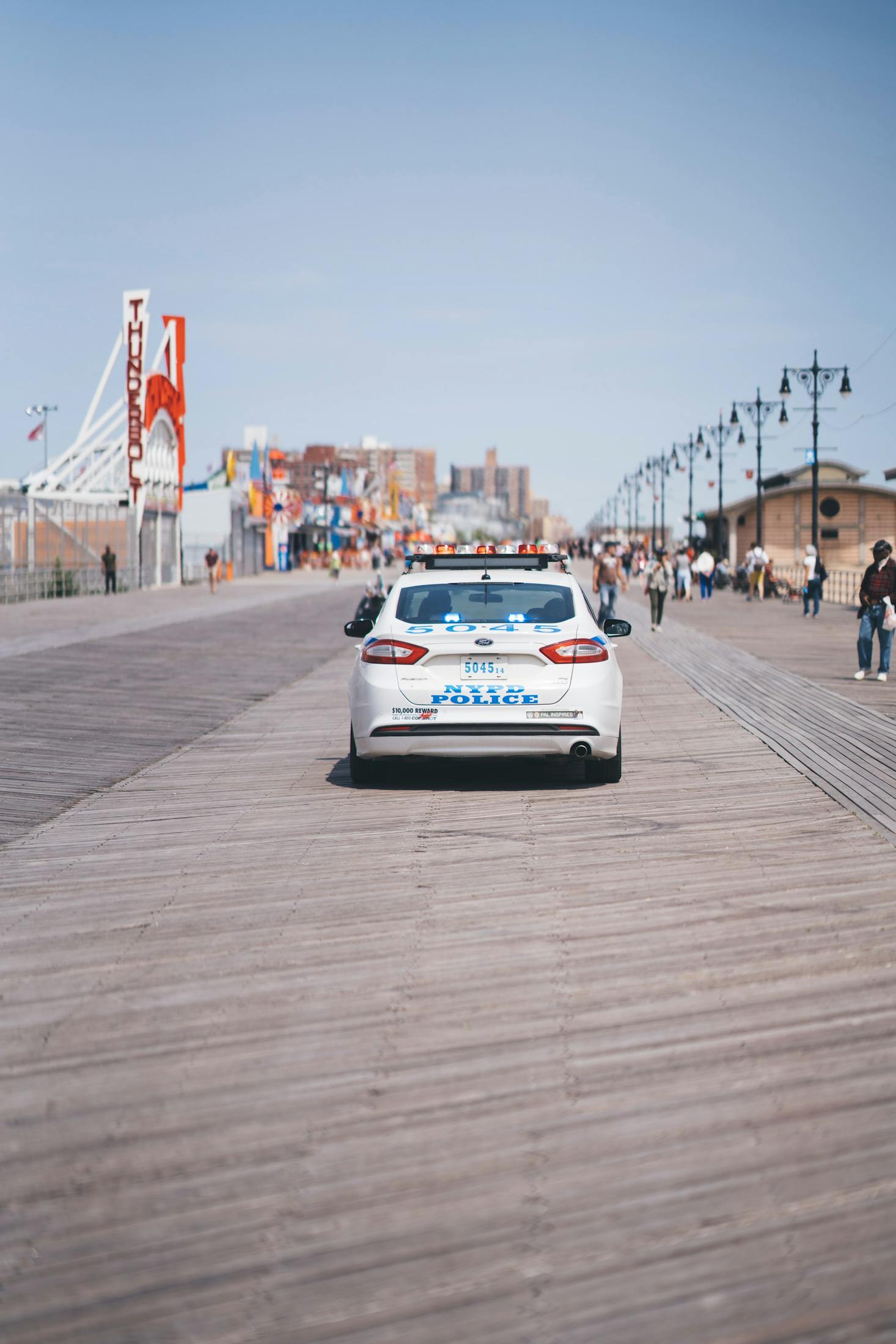 A white police car parked on the Coney Island boardwalk