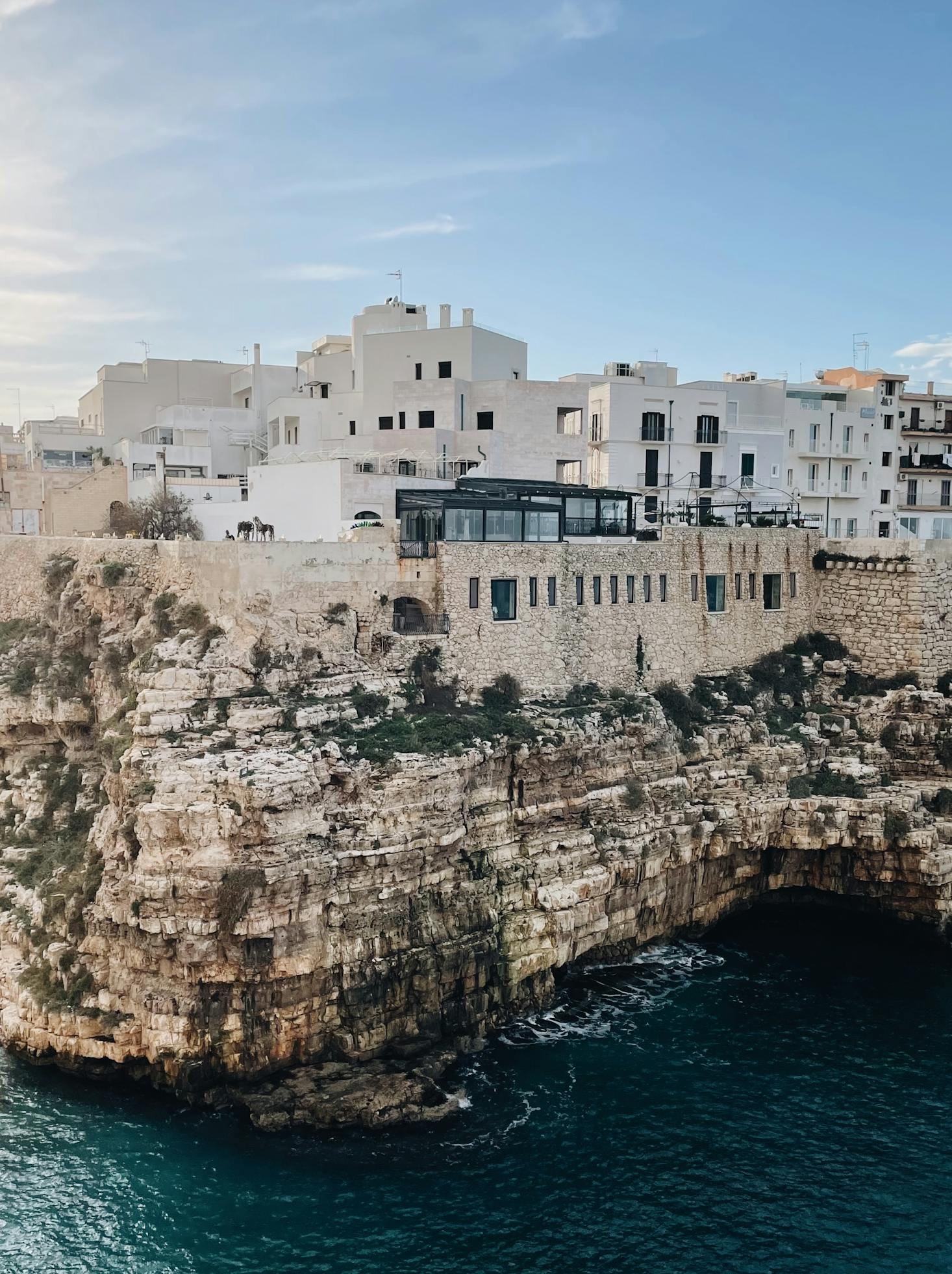 The coastal town of Bari overlooks the Adriatic Sea with a blue sky background