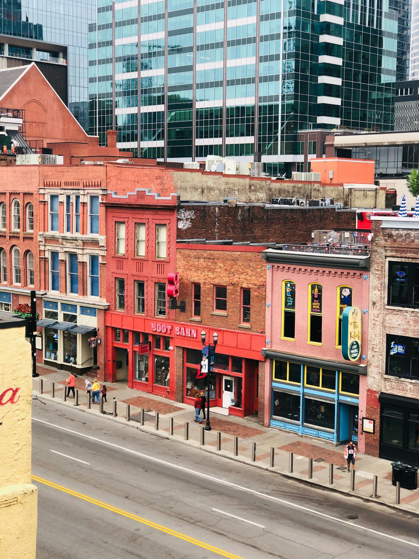 Red and orange-colored bars on Broadway in Nashville in the daytime