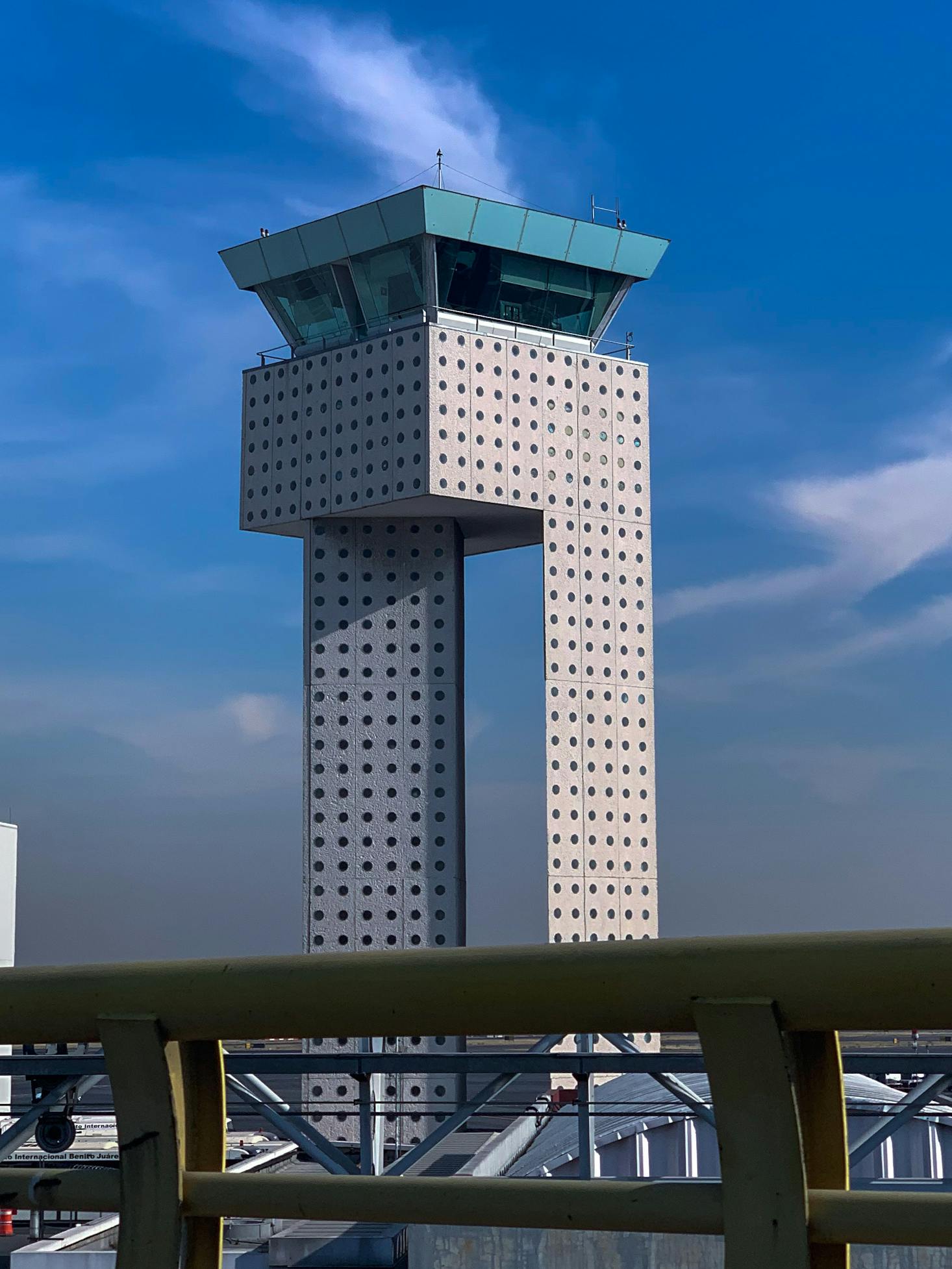 The air traffic control tower at Mexico City Airport on a sunny day