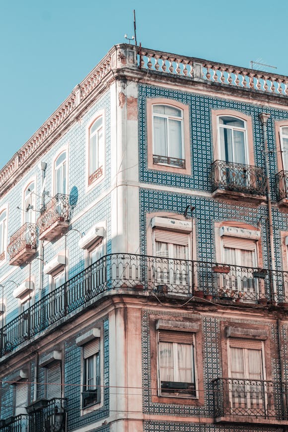 Lisbon apartment block with blue tiles on a blue sky background