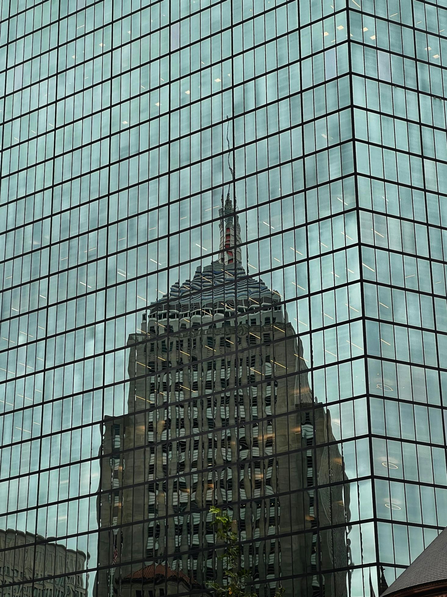 Reflection of a skyscraper in a glass-windowed office building in Boston