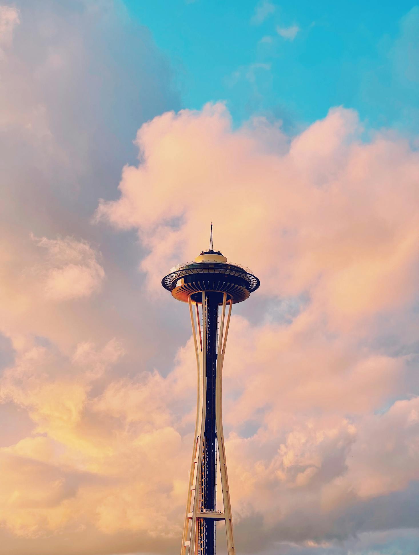 The Space Needle near Seattle's King Street Station with clouds in the distance