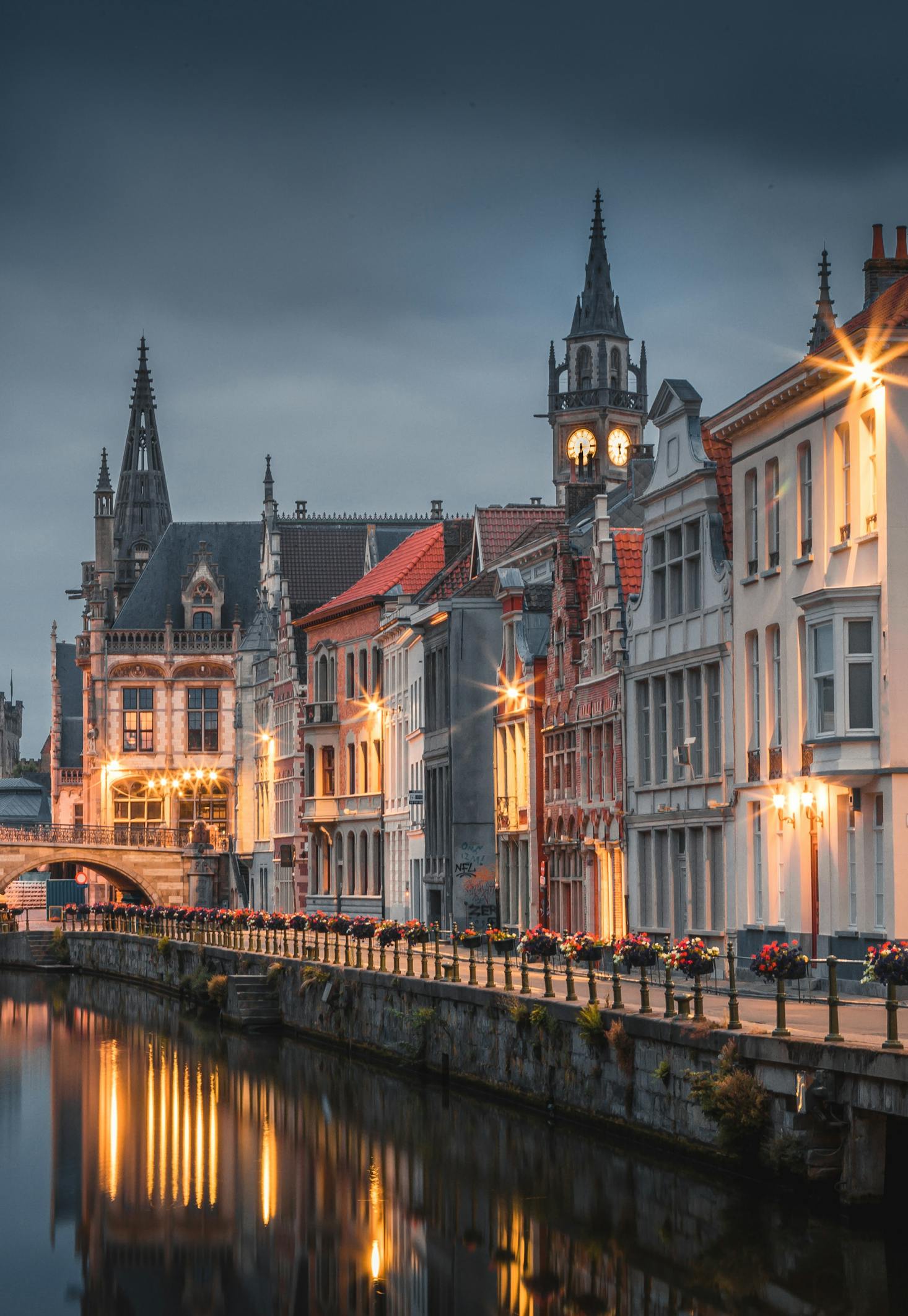 Houses along the water in Ghent lit up at night