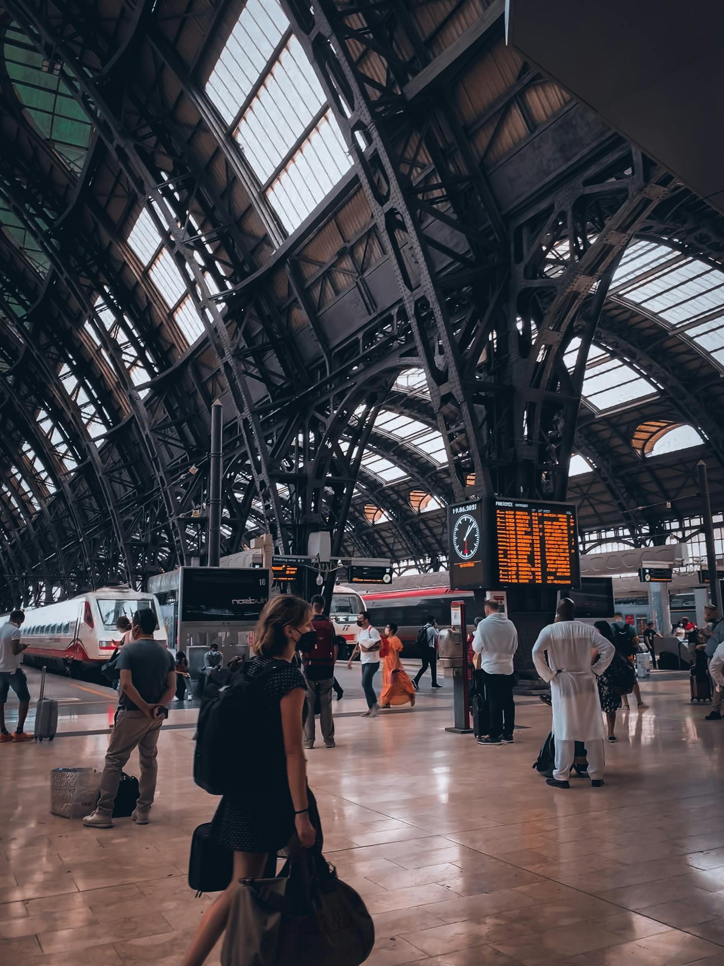 People with bags walking through Milano Centrale Station