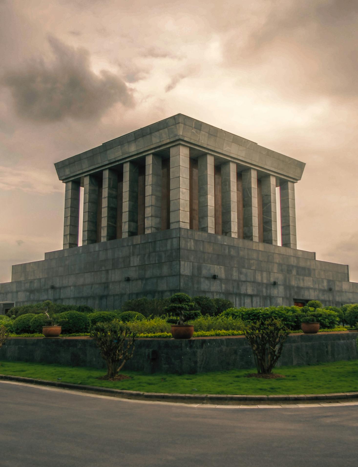 Square monumental-type building against a gray cloudy sky in Hanoi