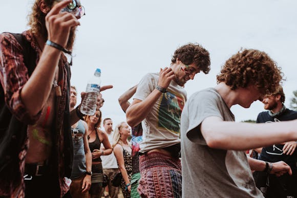 People in vibrant clothes dancing to music, capturing the energetic atmosphere of the Amsterdam Dance Event 