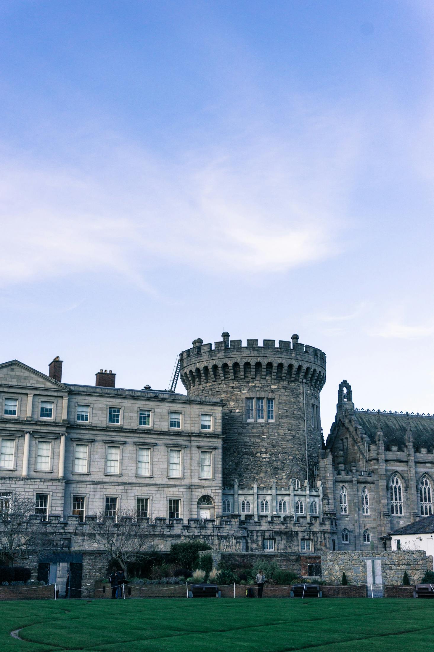 Grey exterior of Dublin Castle with blue sky behind it