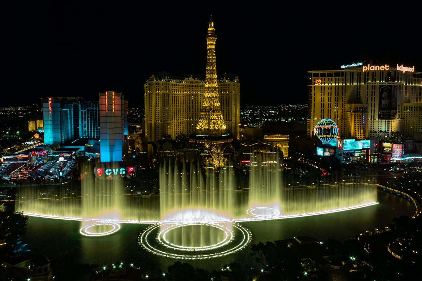 The Bellagio fountains lit up at night during the show