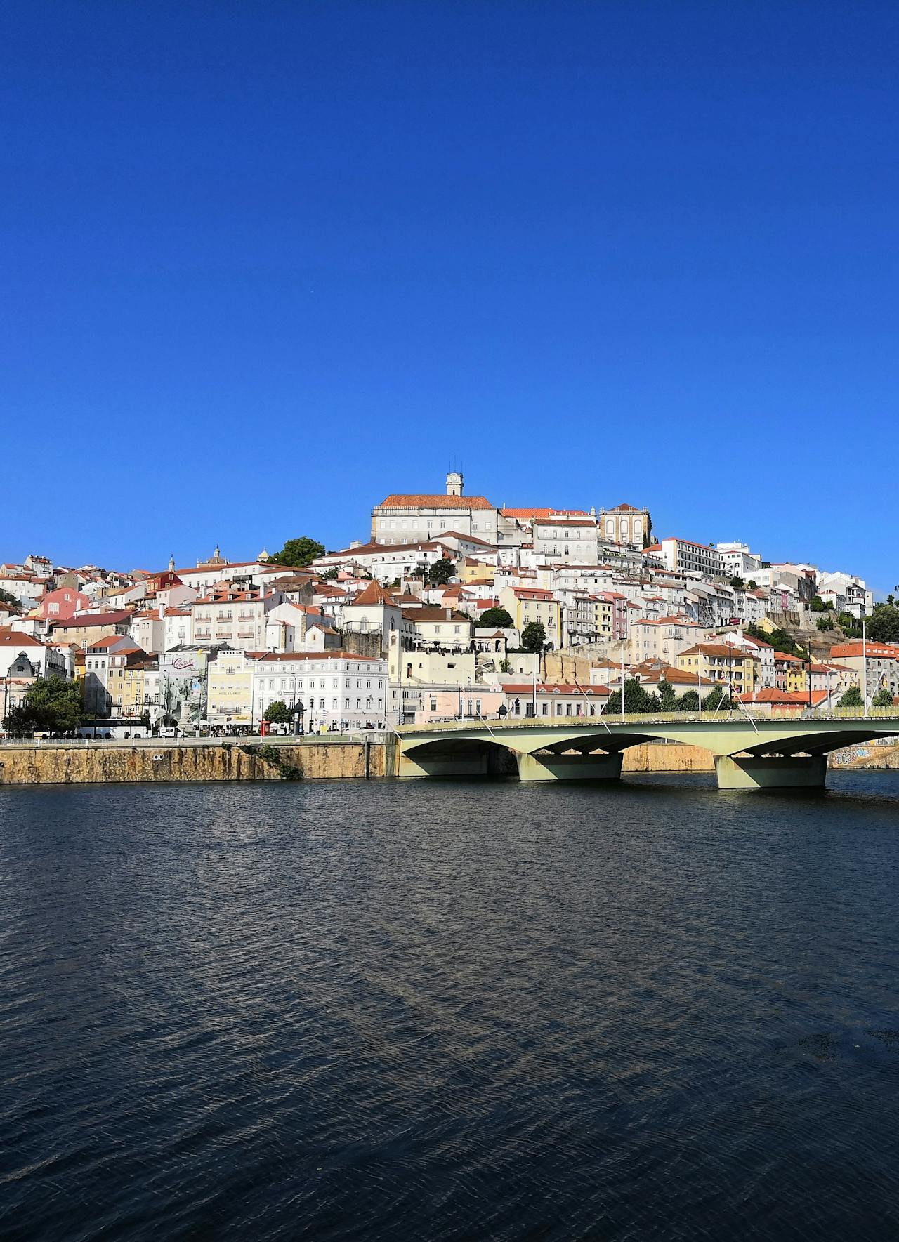 White buildings cascading down a hill in Coimbra on the Mondego River White buildings cascading down a hill in Coimbra on the Mondego River