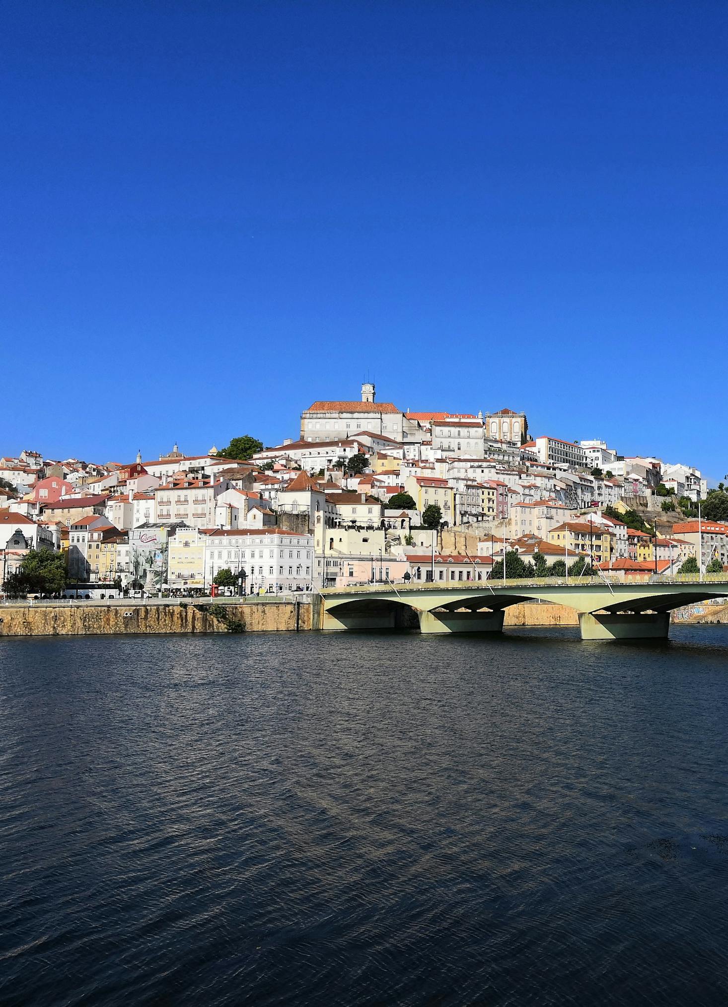 White buildings cascading down a hill in Coimbra on the Mondego River