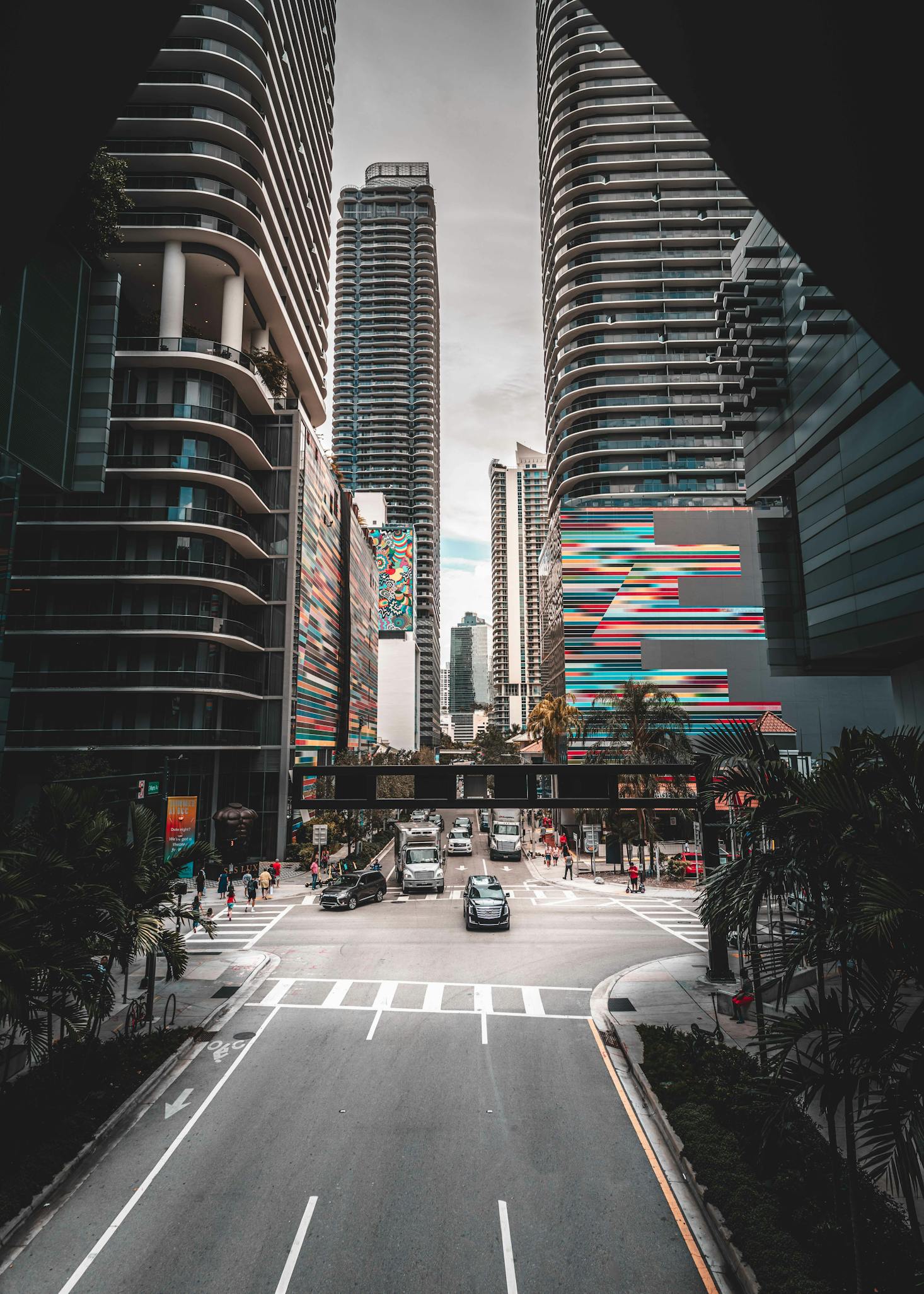 Black skyscrapers contrasted with colorful billboards in Downtown Miami