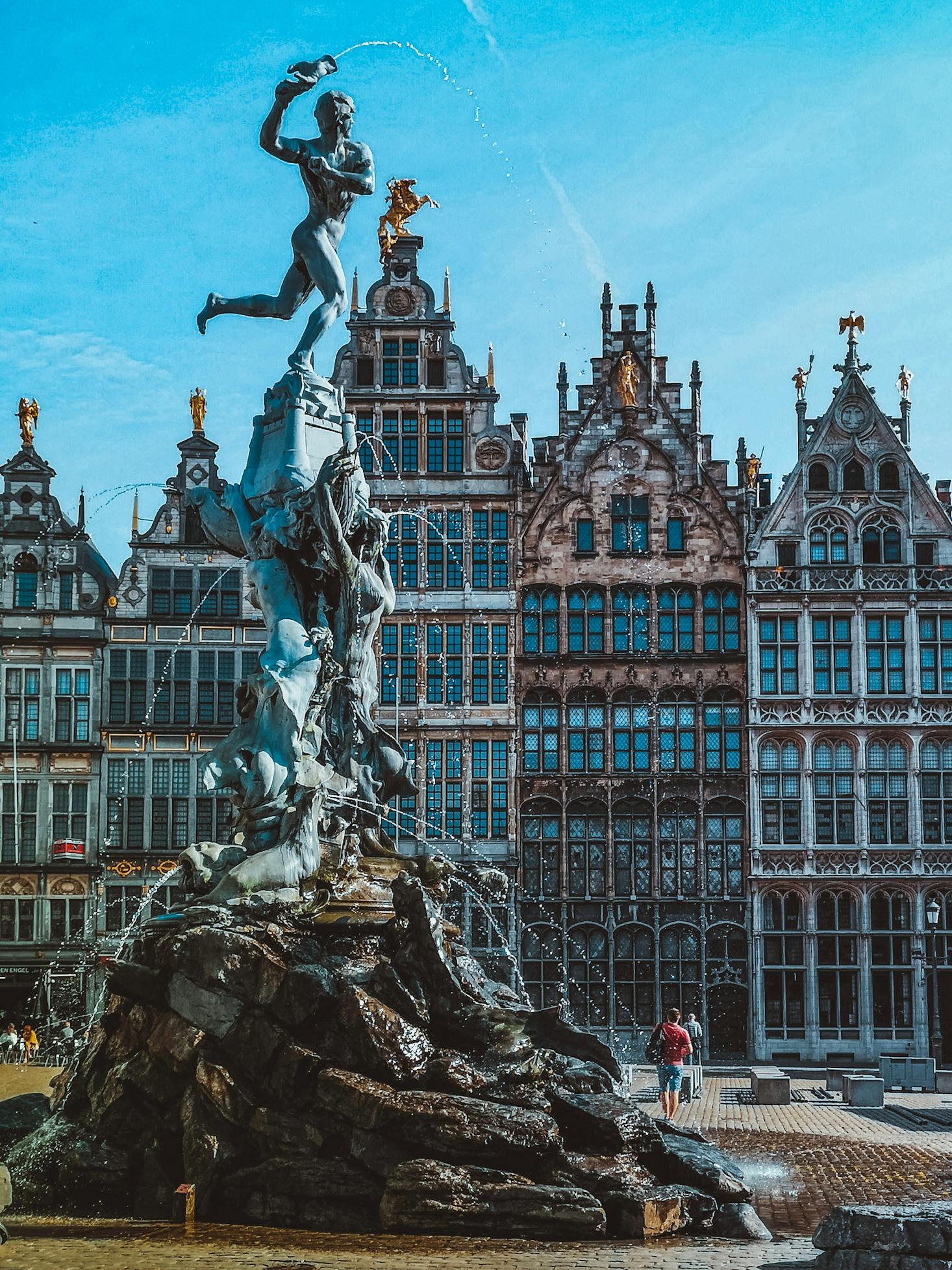 Interesting architecture is displayed in buildings facing a fountain in Antwerp, Belgium