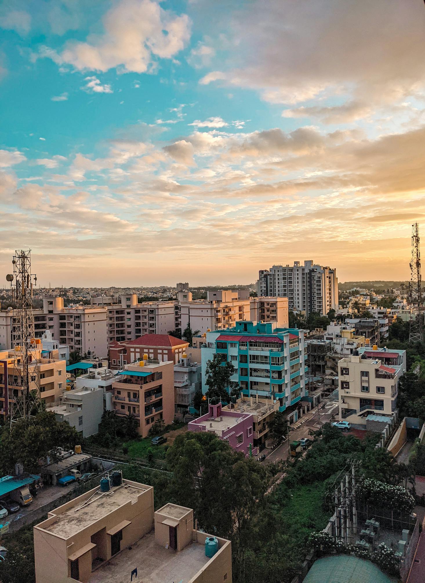 Colorful buildings and highrises frame the cloudy sky in Bangalore, India