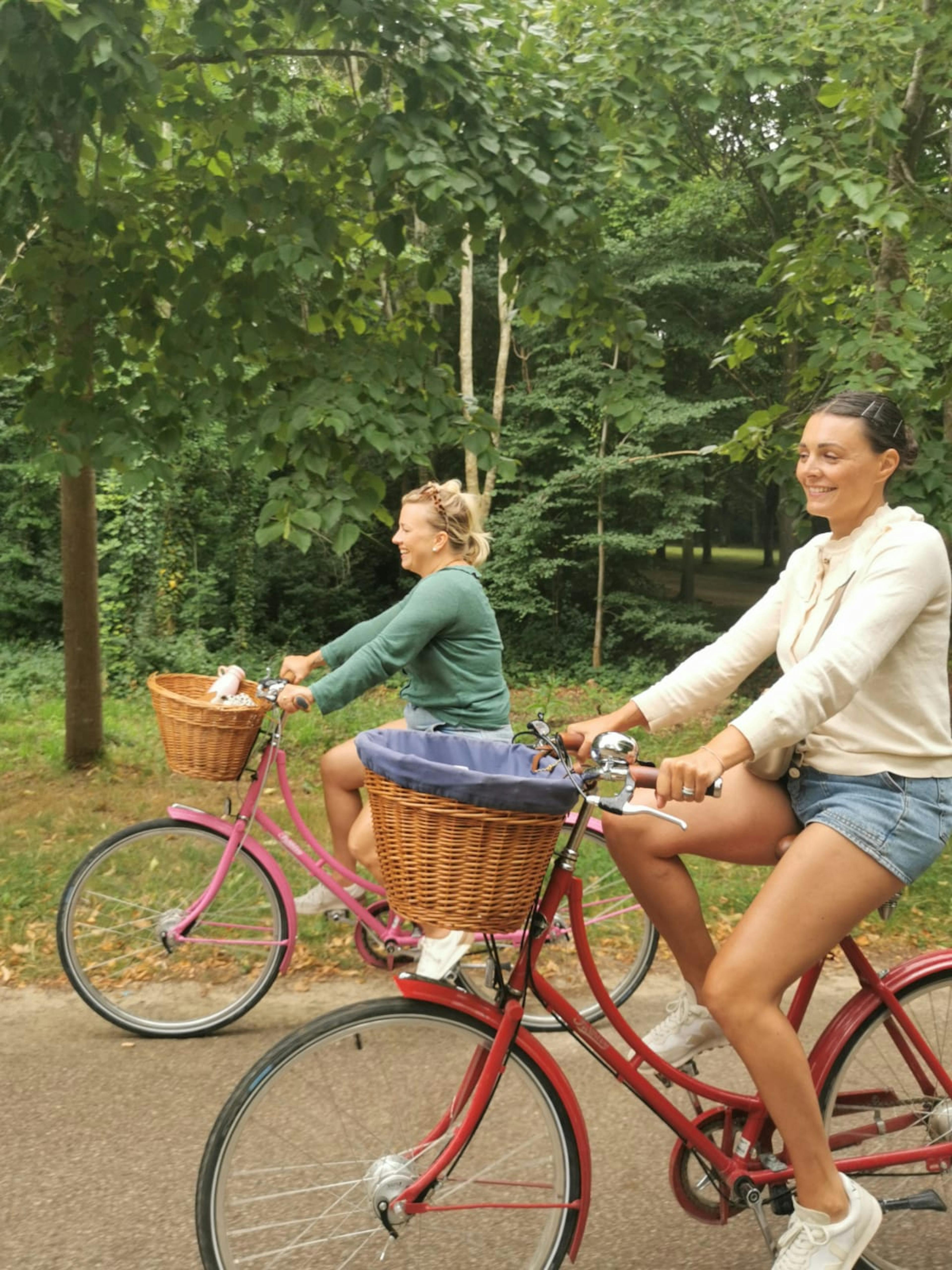 Two women riding in the gardens of Versailles