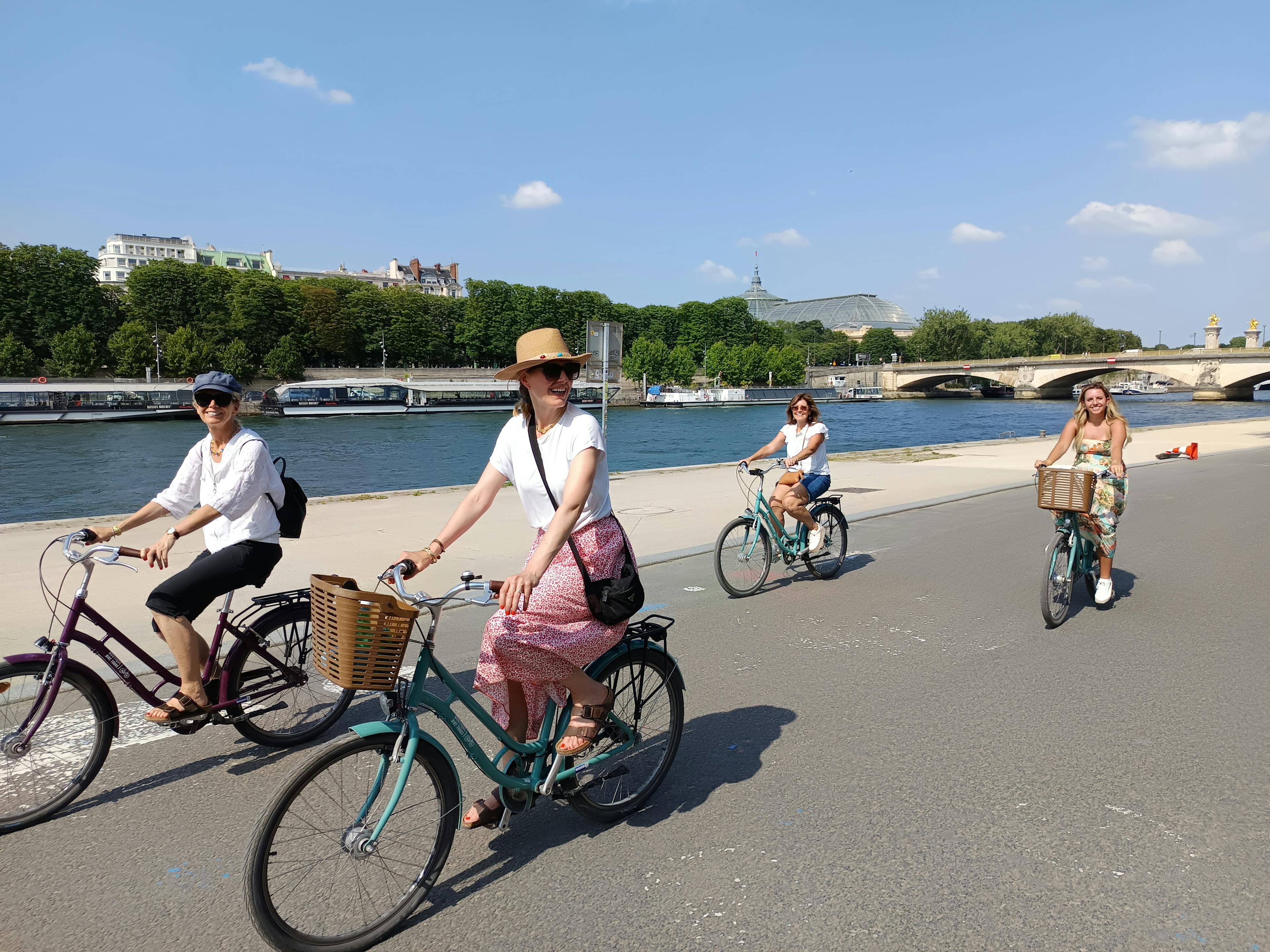 Four women exploring Paris on a bike tour